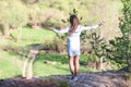 Young beautiful woman standing on the edge of a cliff Royalty Free Stock Photo