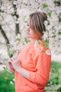 Young beautiful woman standing near blooming white cherry tree Royalty Free Stock Photo