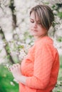 Young beautiful woman standing near blooming white cherry tree Royalty Free Stock Photo