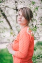 Young beautiful woman standing near blooming white cherry tree Royalty Free Stock Photo