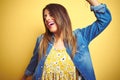 Young beautiful woman standing over yellow isolated background Dancing happy and cheerful, smiling moving casual and confident Royalty Free Stock Photo