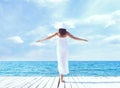 View from the back of beautiful and healthy girl on wooden pier. Vacation, resort and traveling. Royalty Free Stock Photo