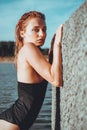 Young beautiful woman standing in the water.