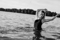 Young beautiful woman standing in the water.