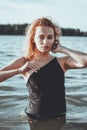 Young beautiful woman standing in the water.