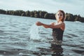 Young beautiful woman standing in the water.