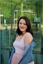 Young beautiful woman stands against the background of the window from which the street is bouncing Royalty Free Stock Photo