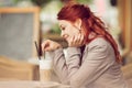 Young beautiful woman in a street cafe enjoying a coffee, summerly urban mood