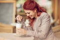 Young beautiful woman in a street cafe enjoying a coffee, summerly urban mood