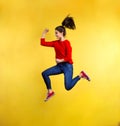 Young beautiful woman in studio, jumping. Royalty Free Stock Photo