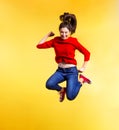 Young beautiful woman in studio, jumping on yellow background. Royalty Free Stock Photo