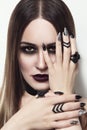 Beautiful woman with stylish gothic make-up and manicure