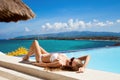 Young beautiful woman sunbathing. Nice sea view. Royalty Free Stock Photo