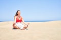 Young beautiful woman sunbathing and relaxing sitting on the sand doing yoga poses at maspalomas dunes bech Royalty Free Stock Photo