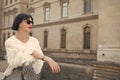 Young beautiful woman in sunglasses walking in Paris, France