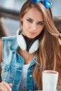 Young beautiful woman at a table in summer cafe Royalty Free Stock Photo