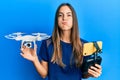 Young beautiful woman taking a selfie photo with smartphone flying drone puffing cheeks with funny face Royalty Free Stock Photo