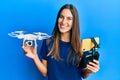 Young beautiful woman taking a selfie photo with smartphone flying drone smiling with a happy and cool smile on face Royalty Free Stock Photo