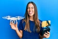 Young beautiful woman taking a selfie photo with smartphone flying drone sticking tongue out happy with funny expression Royalty Free Stock Photo