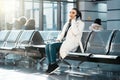 Young beautiful woman talking by mobile phone in modern light airport. Royalty Free Stock Photo