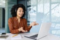 Young beautiful woman talking to customers remotely, african american female worker smiling using headset phone and Royalty Free Stock Photo