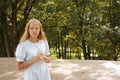 Young beautiful woman thought about it against backdrop of nature