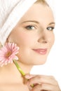 Young beautiful woman in towel with pink flower Royalty Free Stock Photo