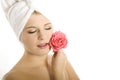 Young beautiful woman in towel with pink flower Royalty Free Stock Photo