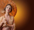 Young beautiful woman in traditional Japanese kimono with umbrella. Royalty Free Stock Photo