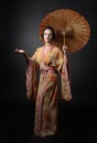 Young beautiful woman in traditional japanese kimono with umbrella. Royalty Free Stock Photo