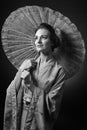 Young beautiful woman in traditional Japanese kimono with umbrella Royalty Free Stock Photo