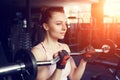 Young beautiful woman training biceps with barbell Royalty Free Stock Photo