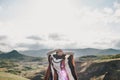 Young beautiful woman traveler wearing hat and poncho relaxing on the top of the hill Royalty Free Stock Photo