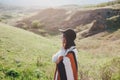 Young beautiful woman traveler wearing hat and poncho relaxing on the top of the hill Royalty Free Stock Photo