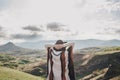 Young beautiful woman traveler wearing hat and poncho relaxing on the top of the hill Royalty Free Stock Photo