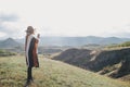 Young beautiful woman traveler wearing hat and poncho taking pictures on her smart phone Royalty Free Stock Photo