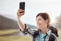 Hiker taking pictures with a smartphone Royalty Free Stock Photo