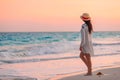 Young beautiful woman on tropical beach in sunset.