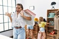 Young beautiful woman with two daughters holding shopping bags at retail shop celebrating victory with happy smile and winner Royalty Free Stock Photo