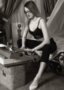 Young beautiful woman typing on a retro typewriter. female writer in bra and men`s trousers. black and white Royalty Free Stock Photo