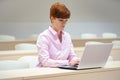 Young beautiful woman on a university lecture working on a laptop Royalty Free Stock Photo