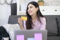 Young beautiful woman is using credit card for online shopping on internet website at home, e-commerce concept Royalty Free Stock Photo