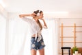 Young beautiful woman using headphone and listening to music and dance in bedroom,Relaxing time,Happy and smiling