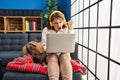 Young beautiful woman using laptop sitting on the sofa annoyed and frustrated shouting with anger, yelling crazy with anger and Royalty Free Stock Photo