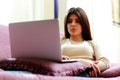 Young beautiful woman using laptop on the sofa Royalty Free Stock Photo