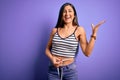 Young beautiful woman using measure tape on waist looking for healthy slim body very happy and excited, winner expression Royalty Free Stock Photo