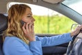 Beautiful woman using smartphone while driving car Royalty Free Stock Photo