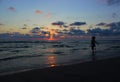 Young beautiful woman walking along the beach at the sea in the evening. Royalty Free Stock Photo