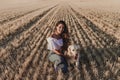 Young beautiful woman walking with her golden retriever dog on a yellow field at sunset. Nature and lifestyle outdoors Royalty Free Stock Photo