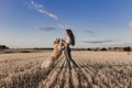 Young beautiful woman walking with her golden retriever dog on a yellow field at sunset. Nature and lifestyle outdoors Royalty Free Stock Photo